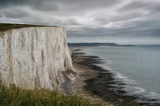 Dover white cliffs and expansive coastline, overcast weather, cinematic landscape.