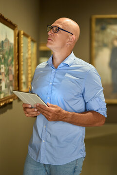 Man in the museum looks at art exhibitions gallery
