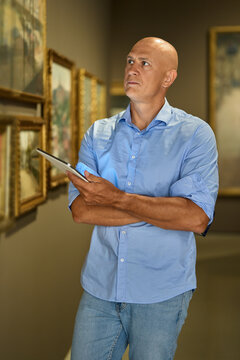 Man in the museum looks at art exhibitions gallery
