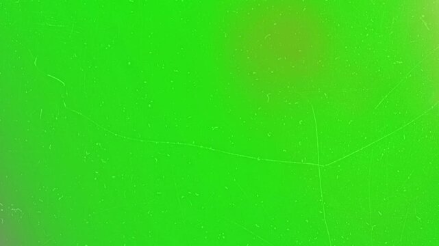 Green screen provides a bright chroma key canvas with delicate dust and scratch patterns that deliver a natural aesthetic for professional video editing and digital compositing projects.