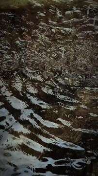 Ripples on a body of water with reflective surface