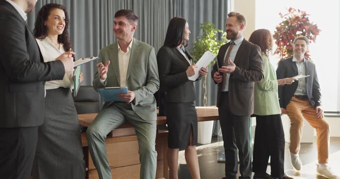 Business professionals networking during office meeting discussion. Colleagues connect and share ideas, expanding networks and trust. Theme conveys teamwork, collaboration and communication.