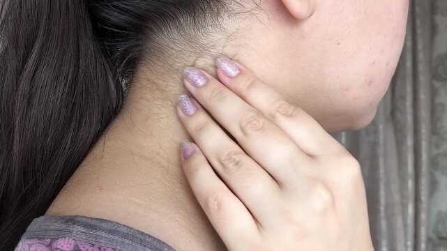 Close up of woman palpating lymph nodes in neck, medical self-check, health monitoring and wellness concept.
