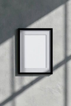 Black picture frame with white paper and shadows