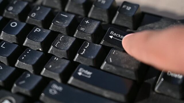 Close Up of a Human Finger Pressing the Backspace Key on a Computer Keyboard While Typing &ndash; Technology, Office Work and Digital Communication Concept 4K Footage
