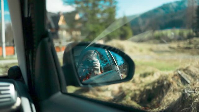 A serene and neutral scene of a car interior observed from the driver's seat in a sunny outdoor landscape with mountains and trees visible through the car windows. The setting features.