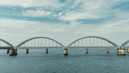 Fototapeta premium Aerial view of an arched bridge over turquoise water