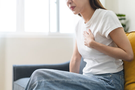 Close-up woman feel nausea touching her throat