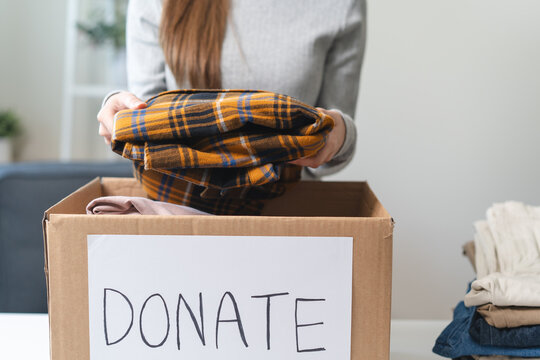 Organize closet and storage concept, people prepare unwanted old fashion clothes for share donation.