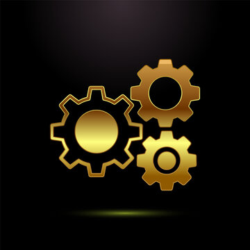 Golden gear wheels icon isolated on black background for engineering mechanical use.