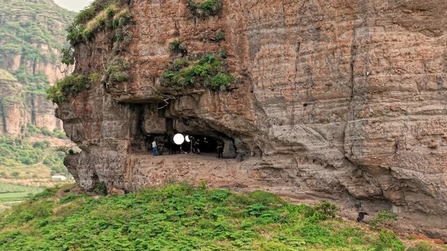 Behind the scenes of a film production in a mountain cave