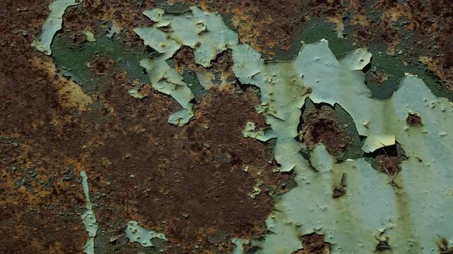 Horizontal Video Pan of Rusted Metal Surface with Peeling Green Paint and Weathered Industrial Texture