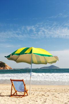 Beach loungers and umbrella by the sea
