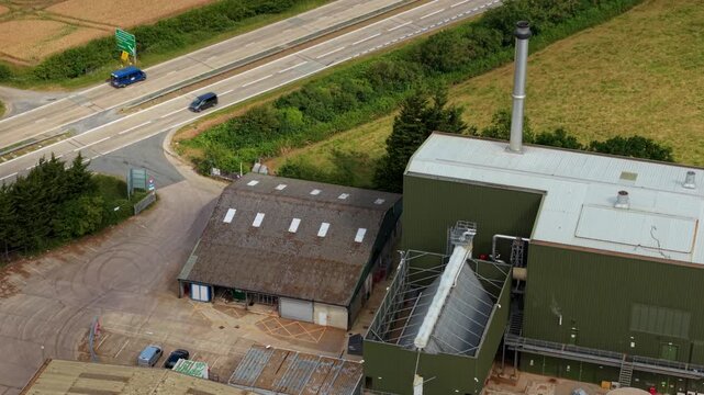 Close up aerial view of giant air-cooled condenser units and rooftop HVAC cooling fans at a modern biomass renewable energy plant.