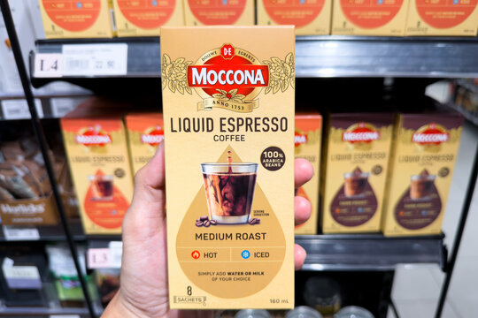 PENANG, MALAYSIA - JUL 03, 2026: Hand holding Moccona Liquid Espresso coffee box inside supermarket grocery store.