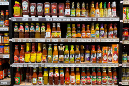 PENANG, MALAYSIA - JUL 06, 2026: Assorted chilli sauces and condiments displayed on supermarket grocery shelf.