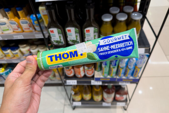 PENANG, MALAYSIA - JUL 06, 2026: Hand holding Thom gourmet horseradish cream tube inside supermarket grocery store.