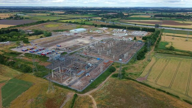 Close up aerial view of electrical substation infrastructure, high voltage transformers and busbars