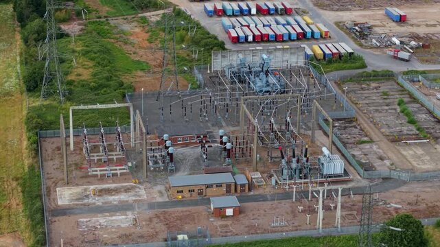 Close up aerial view of electrical substation infrastructure, high voltage transformers and busbars