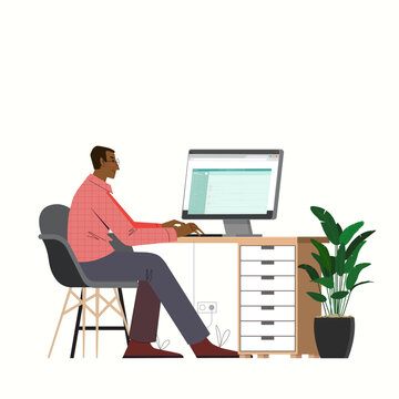 A freelancer man works behind a laptop. Home office workplace.