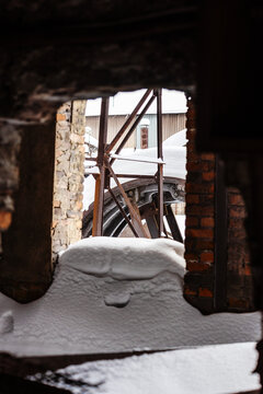 snow-covered broken window on abandoned factory