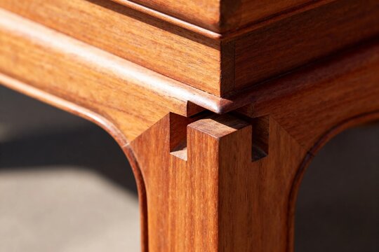 Close-up of wooden furniture joint showcasing dovetail craftsmanship