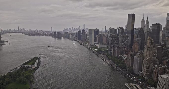NYC New York Aerial v322 drone flyover East river, panning views capturing waterfront United Nations and Midtown Manhattan cityscape against overcast sky - Shot with Mavic 3 Pro Cine - September 2023