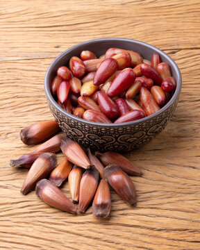 Cooked pinions or araucaria seeds on a bowl over wooden table