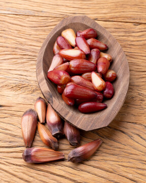Cooked pinions or araucaria seeds on a bowl over wooden table