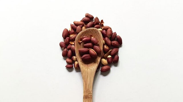 Roasted peanuts Arachis hypogaea on wooden spoon from Guatemala