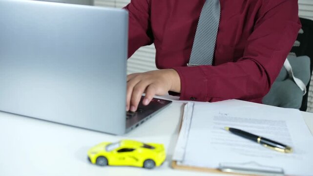 Buying and selling cars online. A man wants to buy a used car. He's browsing through numerous used car listings online on his laptop to compare prices. Many automobiles with picture detail 

