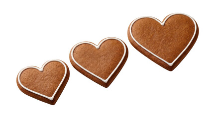 Obraz premium Three heartshaped gingerbread cookies with white icing isolated on transparent background