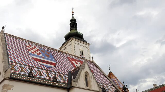 ZAGREB, CROATIA - JULY 12 2017: Church of St. Mark is parish church of old Zagreb, Croatia, located in St. Mark's Square. Coat of arms of Triune Kingdom of Croatia, Slavonia, and Dalmatia, and city