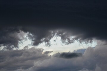 Obraz premium Dramatic storm clouds background with light breaking through.