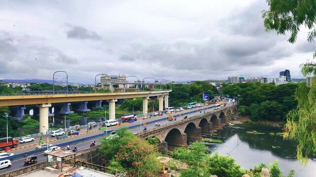 Vehicle moves along the Pune metro rail road near Sangam Bridge, now the Indian urban mass transit metro railway system.