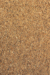Vertical close-up of a natural brown cork board texture. Concept of office notice board, school bulletin, and blank background. © Win Nondakowit