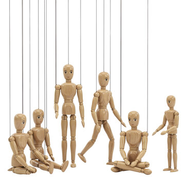 Group of wooden marionette puppets with strings attached, articulated human figures in various poses, isolated on a white background, studio shot