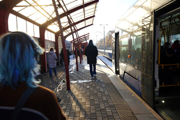 Fototapeta premium tram stop and several passengers