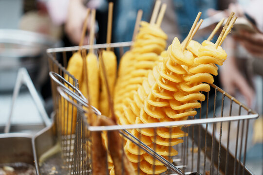Chinese viral snack, tornado potato tower, skewered deep-fried potato slices.