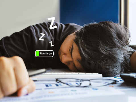 Exhausted Office Worker Sleeping at Desk with Recharge Battery Concept