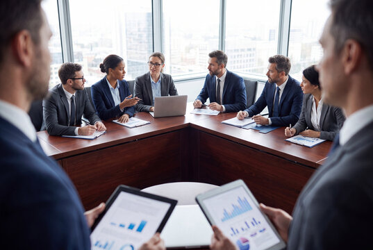 Corporate Board Meeting with Business Executives Around Conference Table