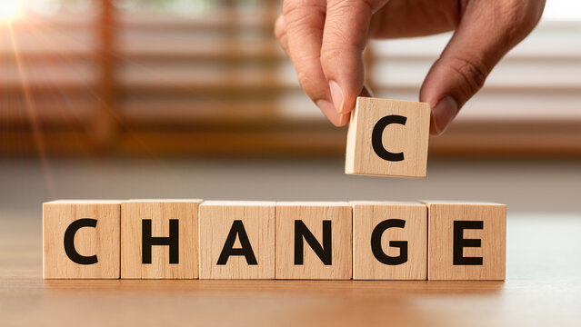 Close up of a businessman hand changing the word CHANCE to CHANGE with wooden blocks. A concept of personal development, business strategy, motivation, and embracing new opportunities
