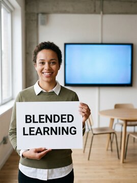 Smiling young woman holds a sign reading blended learning in a modern office