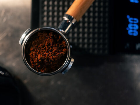 Ground coffee in portafilter on scale