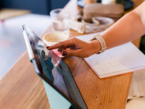 Woman using digital tablet at coffee shop 