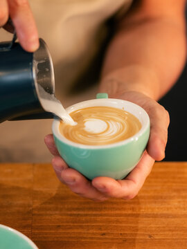 Barista Pours Milk Into Coffee Cup for Latte Art Design