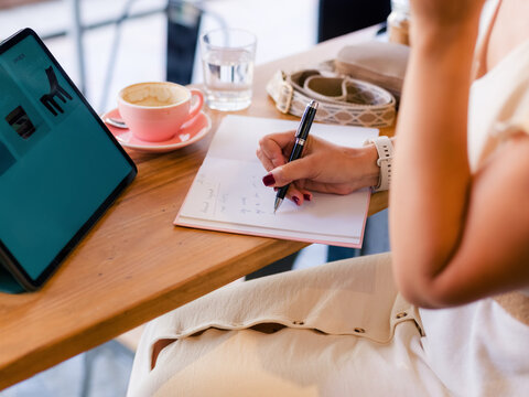 Woman working at cafe during the day 