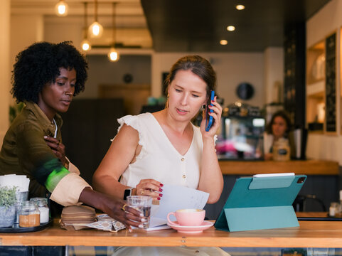 Waitress serving busy guest at cafe 