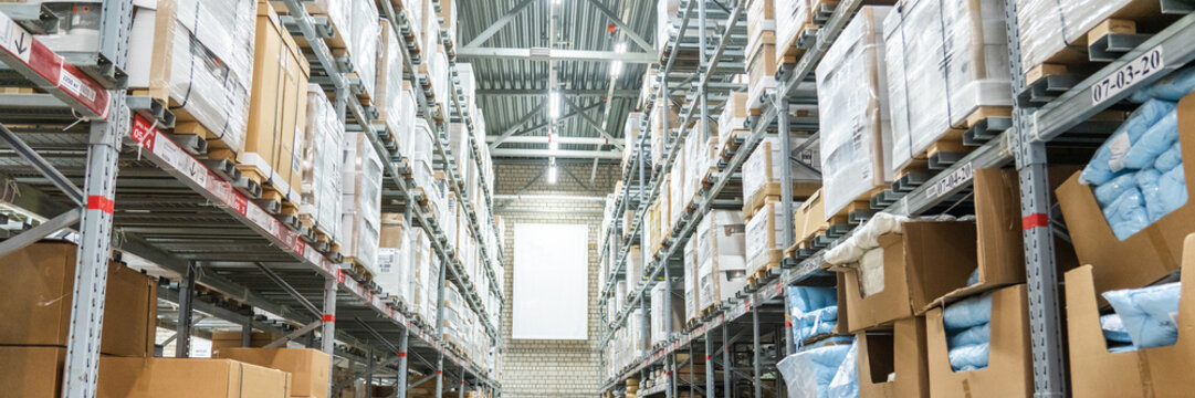 Rows of shelves with boxes in big warehouse