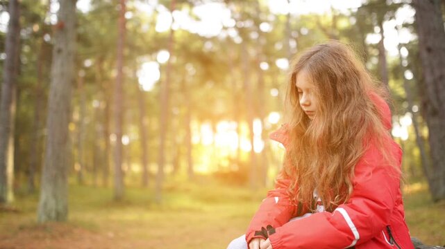 Little sad girl in red jacket